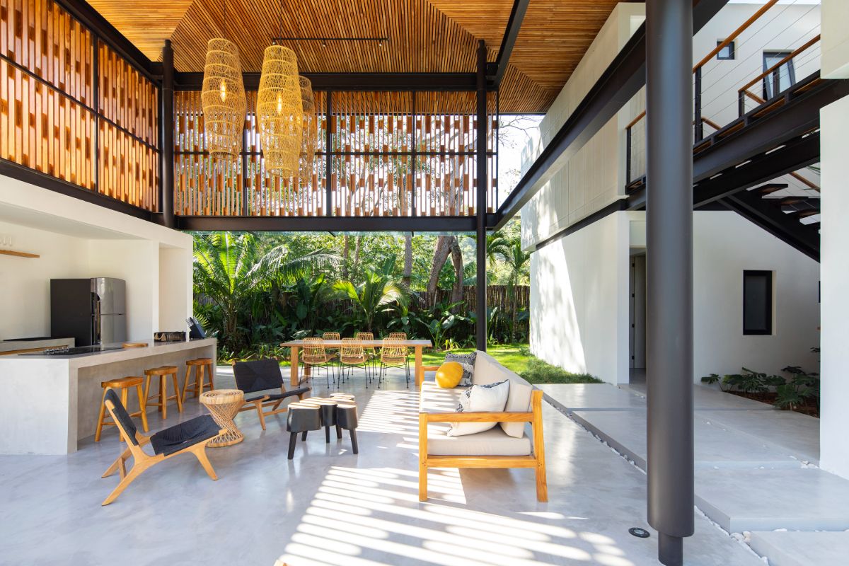 The primary living rooms are made up of light-weight steel frames that hold open spaces that welcome nature inside, as well as long steel rooflines coated in teak.