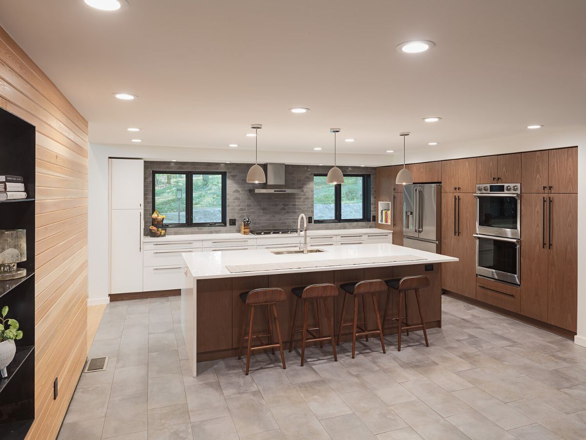 A new walnut kitchen with increased visibility to the lofty living room space and link to dining was installed.