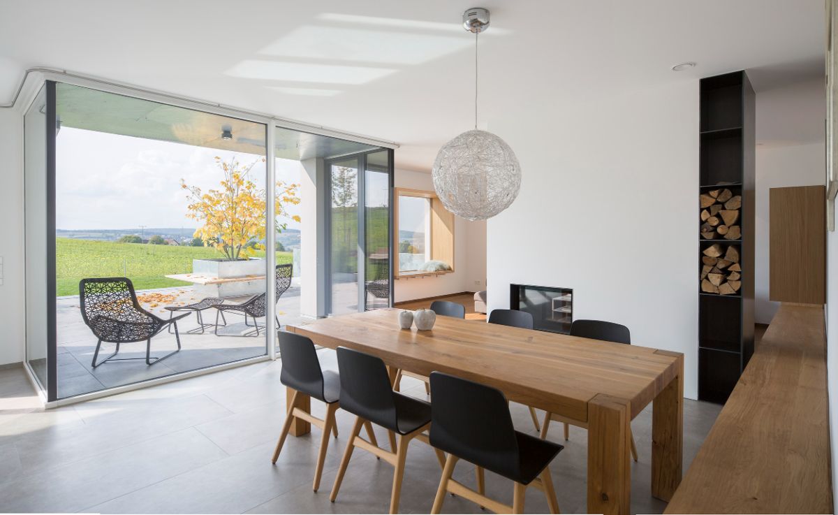 A long bench connects the dining area to the living room and turns neatly into living room furnishings.