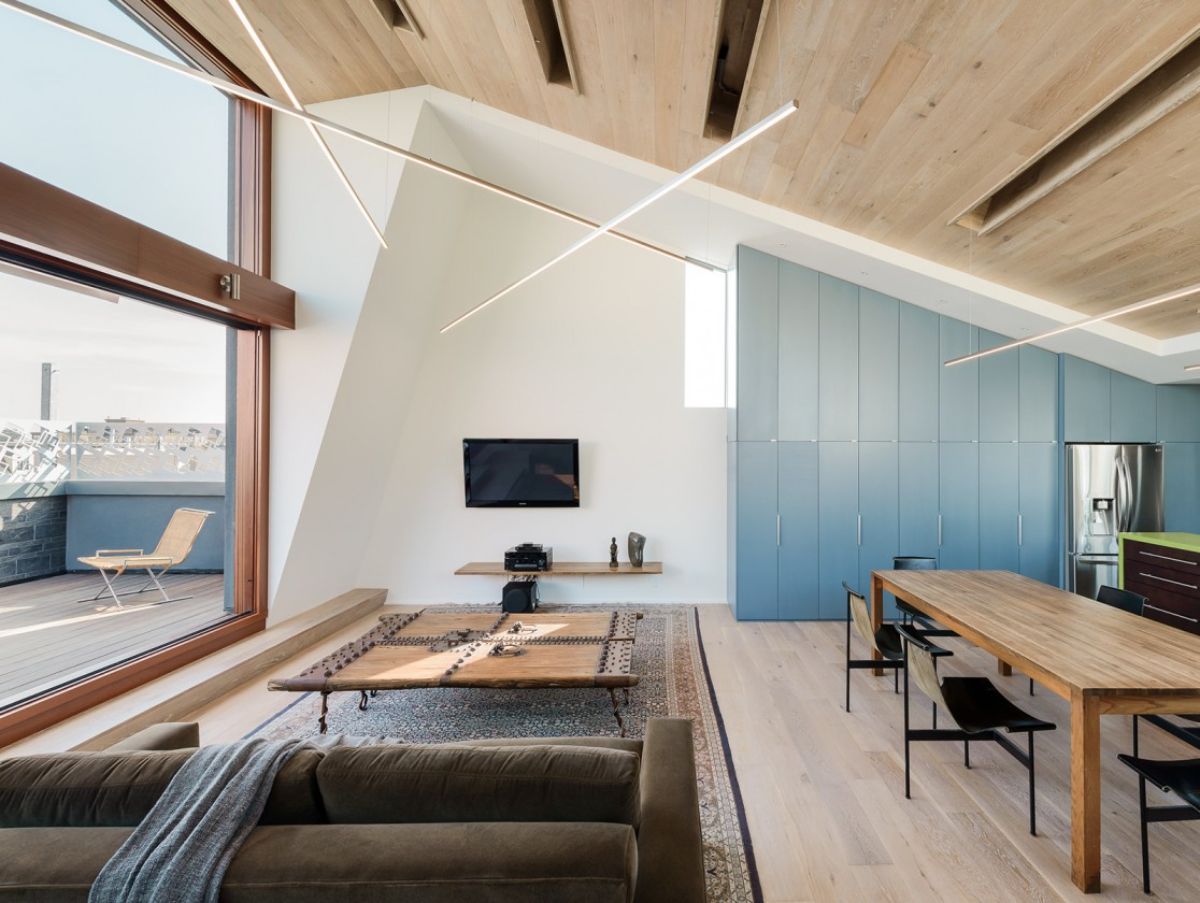 The "sky house" in the third unit has an open layout as well, with clean-lined kitchen fittings and rustic dining that extends all the way to the ceiling. It also features a terrace with views of the street and nearby residences.