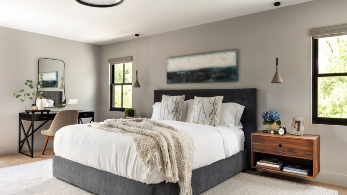 Modern in style, the master bedroom features a combination of grey, white, and black.