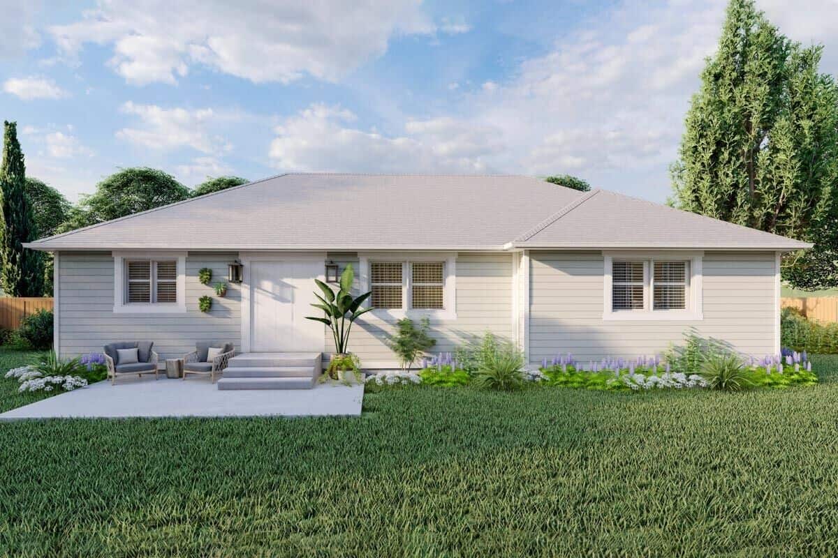 Rear rendering with a concrete patio furnished with cushioned armchairs.
