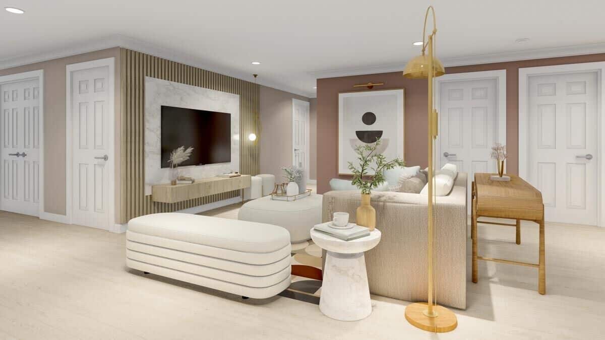 The lower-level family room has contemporary furnishings and a TV mounted against the marble panel.
