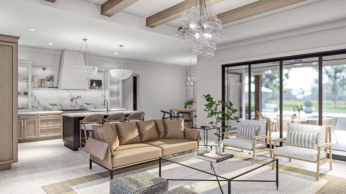 The great room has modern seats and a glass-top coffee table under a beamed ceiling.