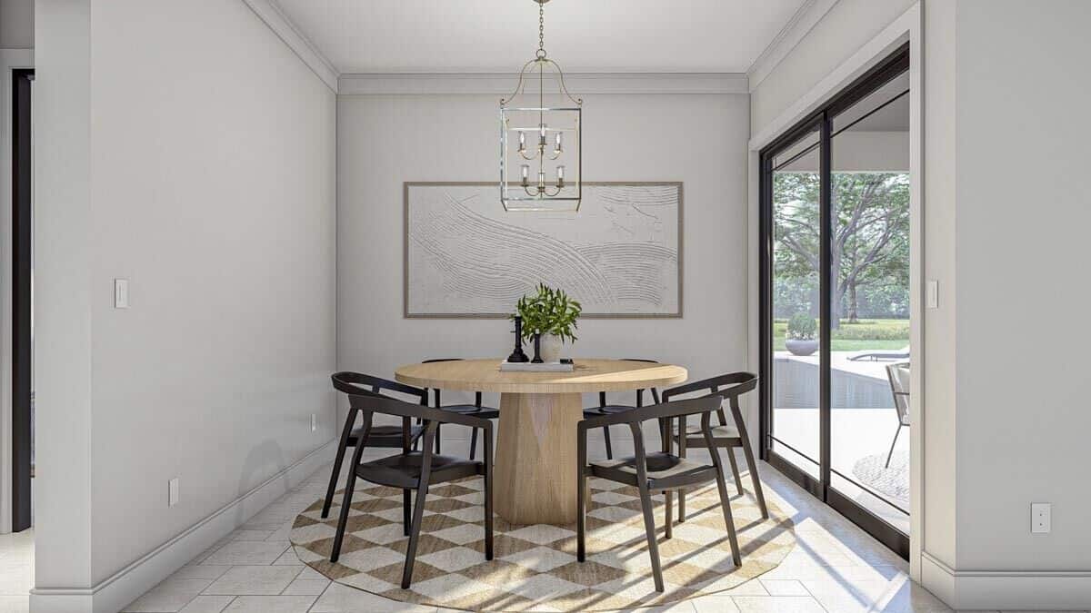 The dining area offers a round dining set and direct access to the covered lanai.