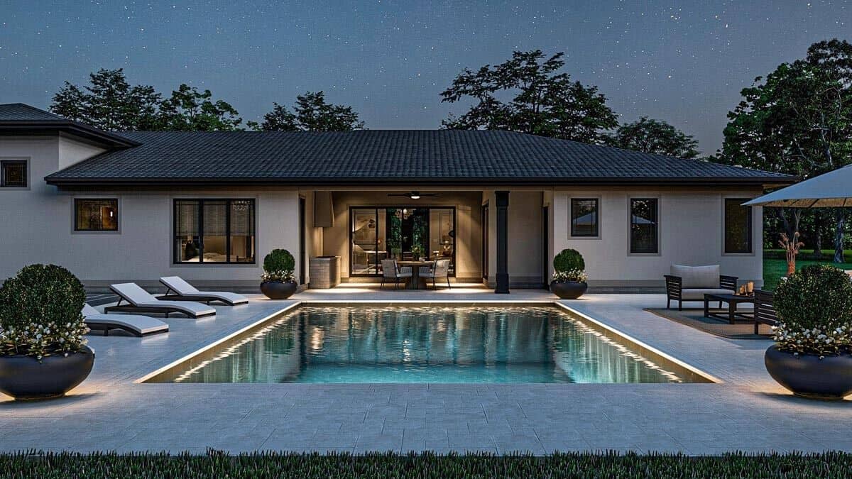 Night view of the house from the backyard showcasing its pool deck.