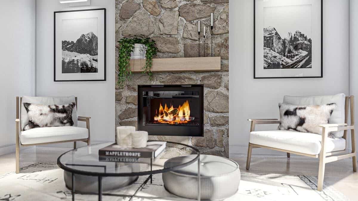 A closer look at the stone fireplace flanked by black and white artworks.