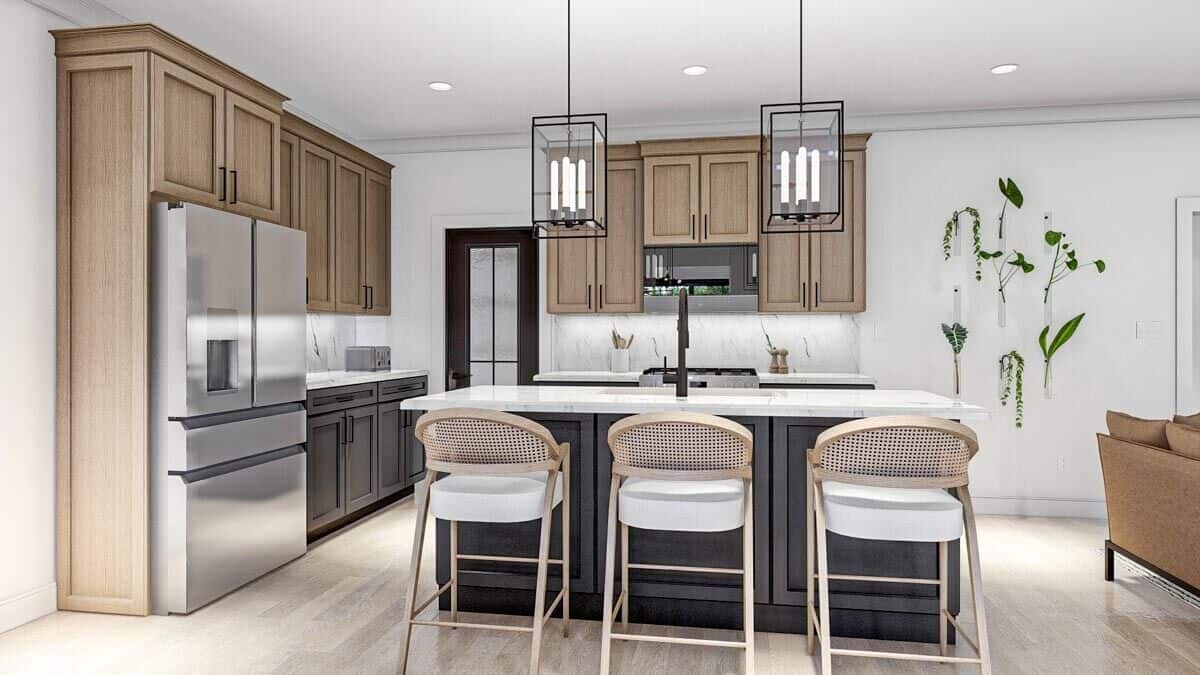The kitchen is equipped with stainless steel appliances, marble countertops, contrasting cabinetry, and a breakfast island.