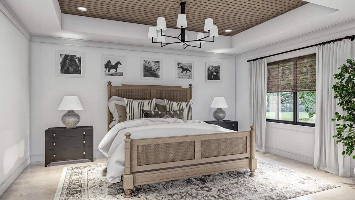 A tray ceiling clad in wood planks crowns the primary bedroom.
