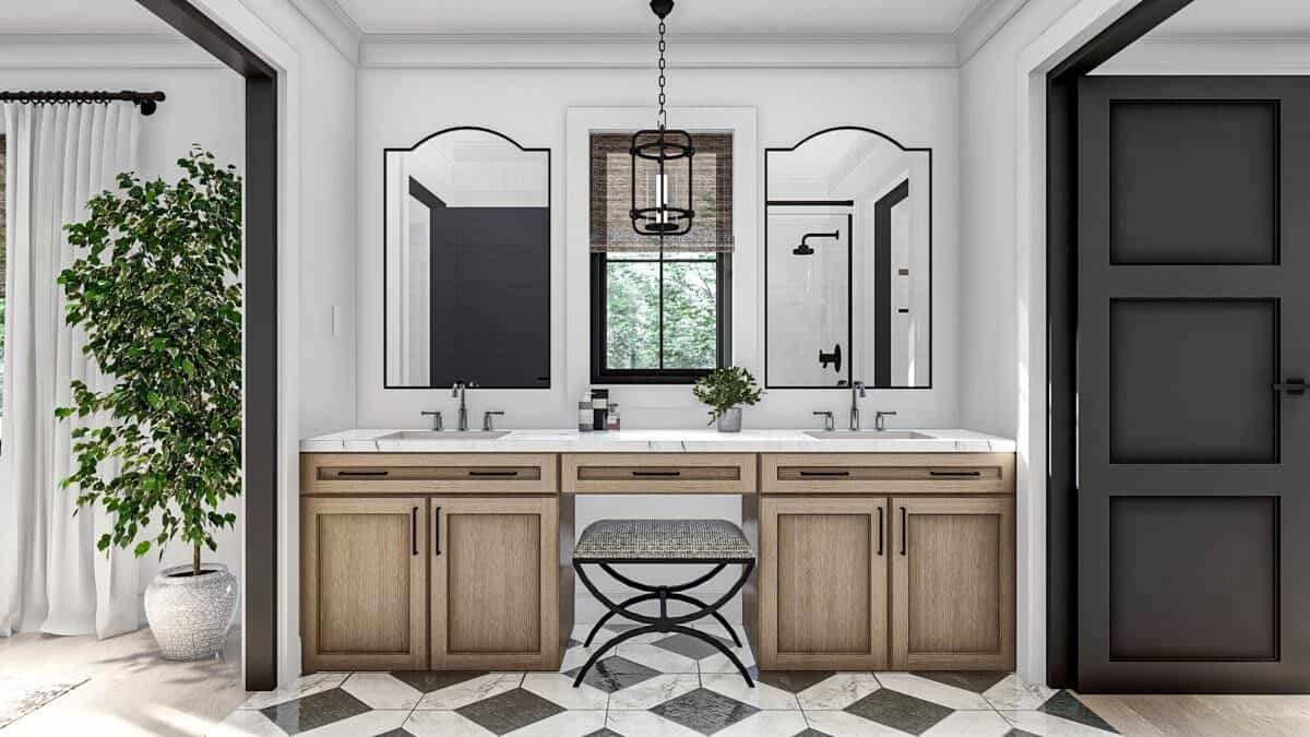 The primary vanity is equipped with two sinks, a makeup counter, a marble countertop, and decorative mirrors.