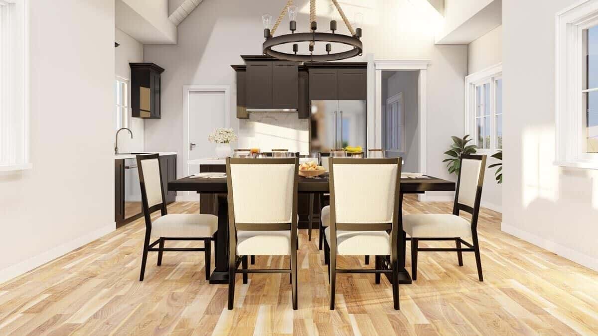 Dining area with round chandelier and a wooden dining set for six.