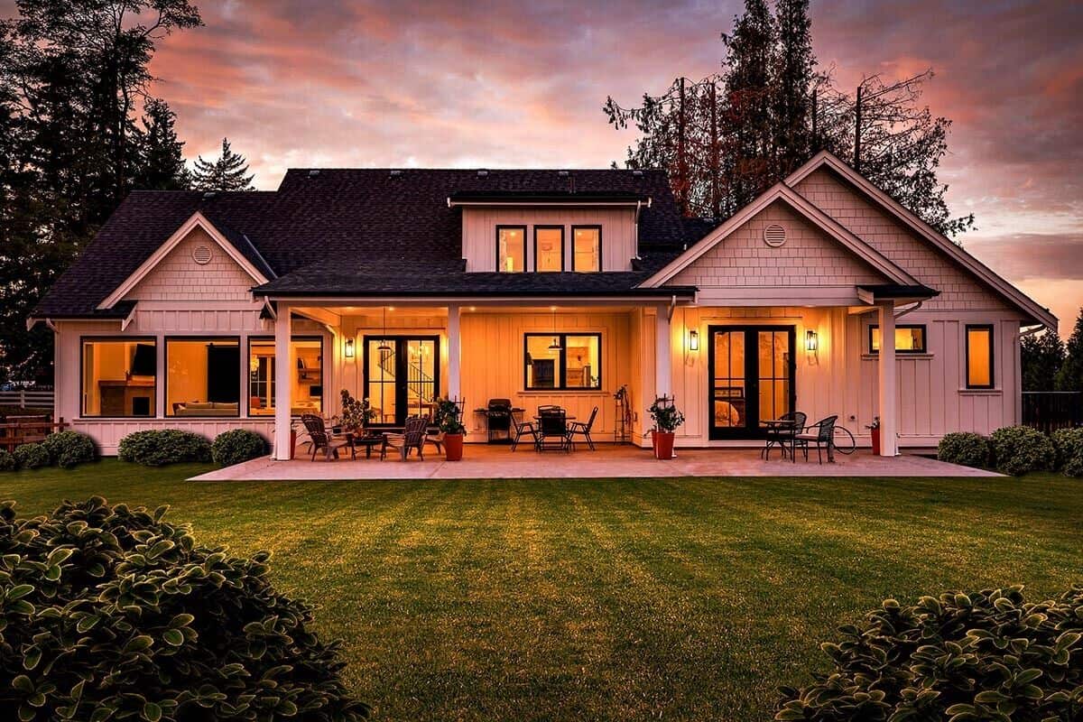 Rear exterior view with covered porches and large windows.