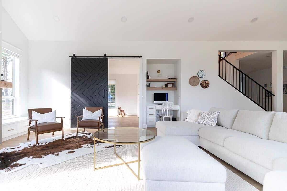 Across the great room is a built-in desk and a sliding barn door that opens to a playroom.