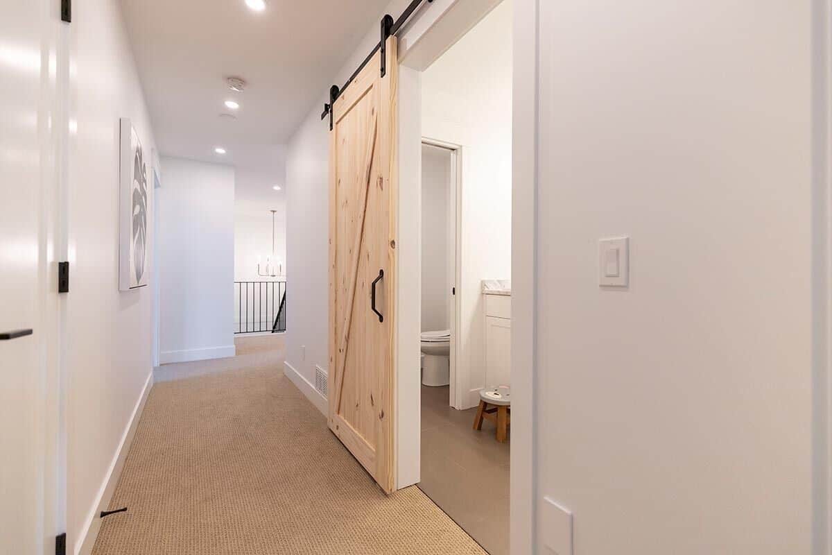 A sliding barn door upstairs reveals the shared bathroom.