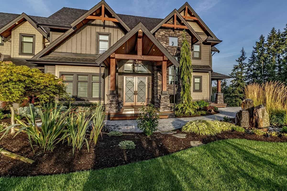 Front exterior view with a covered entry porch and multiple gables adorned with wooden trims.