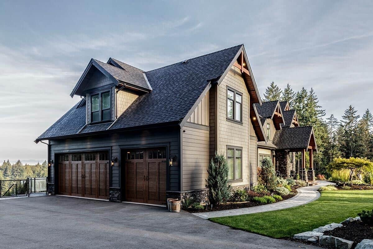 Left exterior view with a side-loading garage topped by a large dormer window.