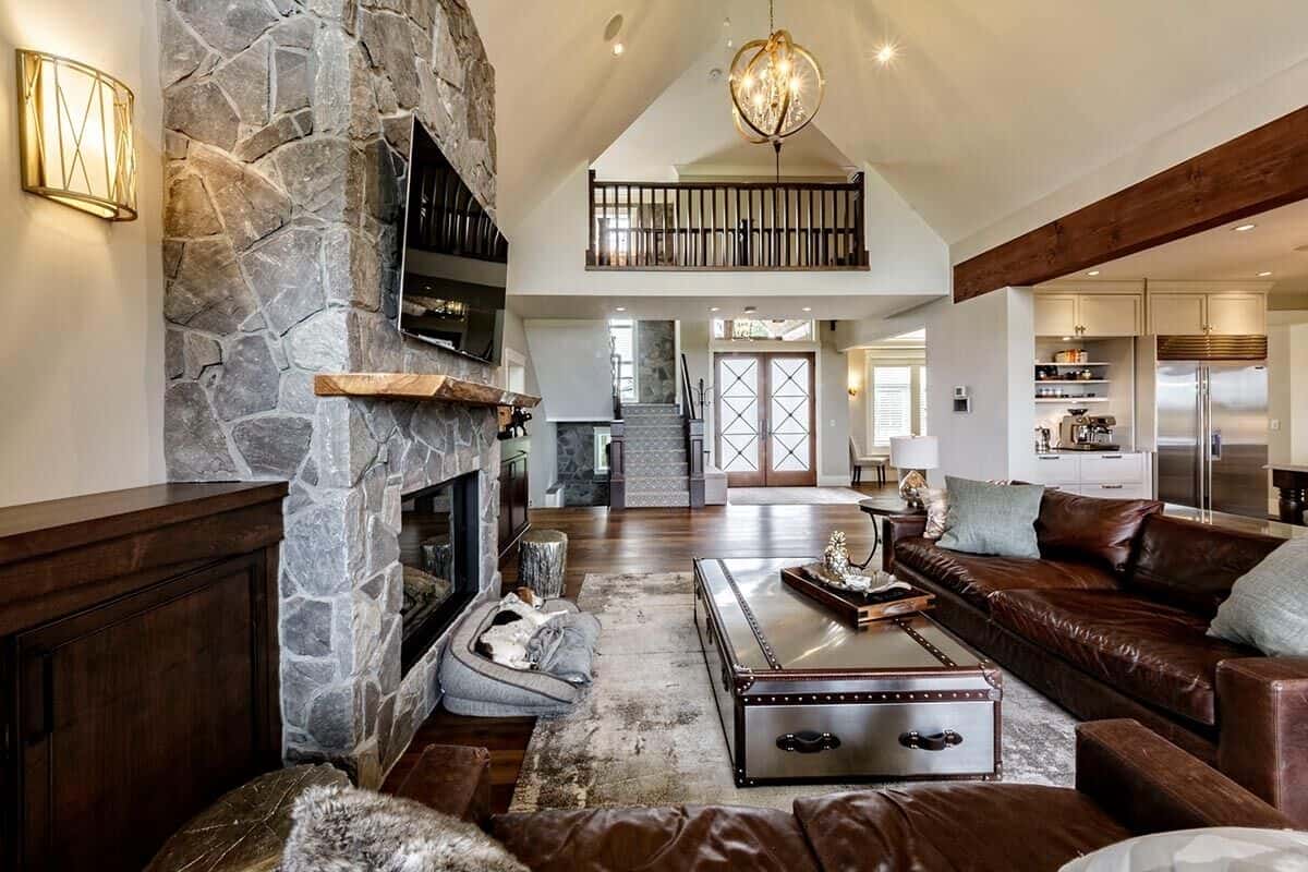 Great room with leather sofas and a large coffee table sitting on a distressed area rug.