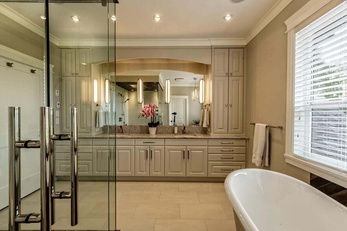 Primary vanity with white cabinets, two sinks, and marble countertop.