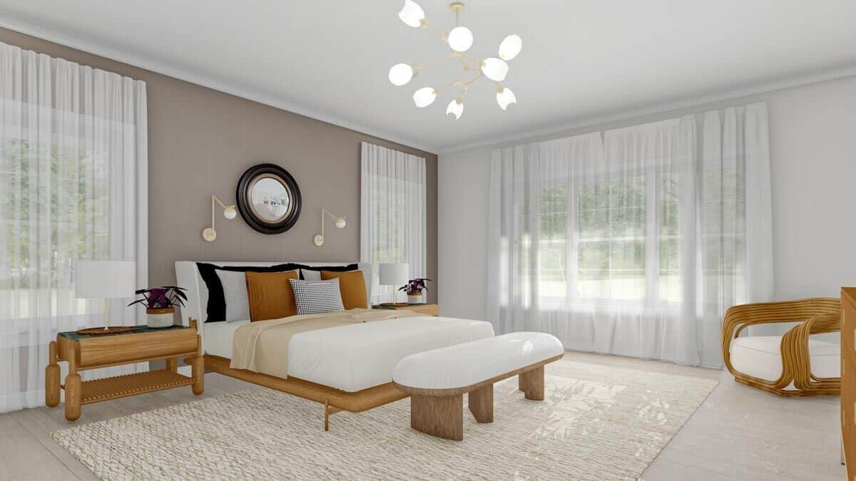 Primary bedroom with wooden furnishings and large windows bathing the room with ample natural light.