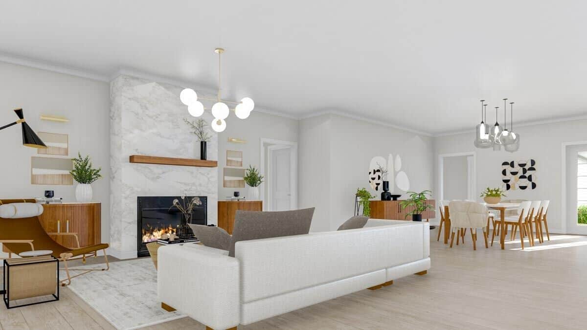 The great room features a modern sofa and a marble fireplace flanked by base cabinets.