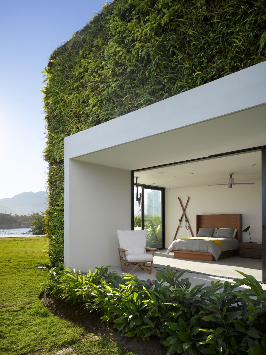 The first-floor bedroom is surrounded on three sides by floor-to-ceiling windows, and rooftop gardens have been installed.