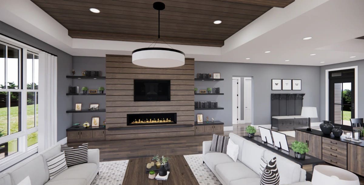 The great room offers a TV and a large fireplace flanked by wooden built-ins.