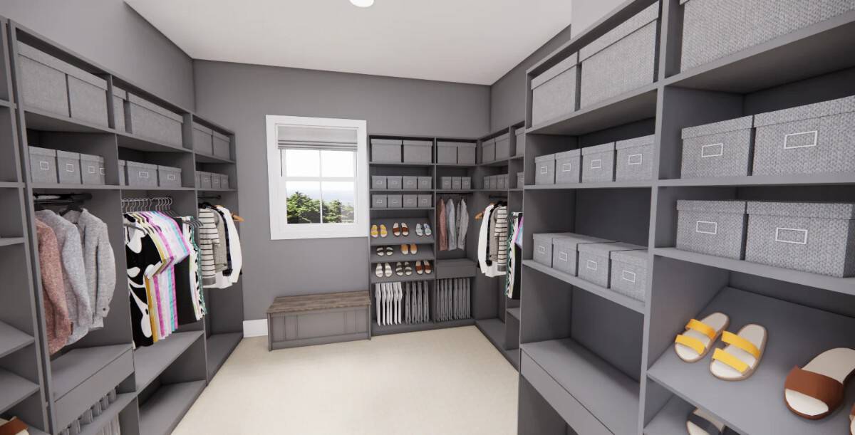 The primary walk-in closet is spacious and includes plenty of storage and a bench beneath a framed window.