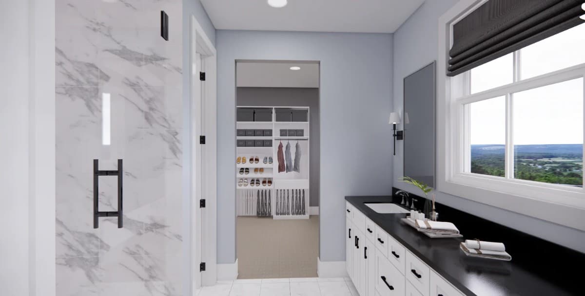 The primary bathroom has a dual sink vanity, a tiled shower, and a walk-in closet.