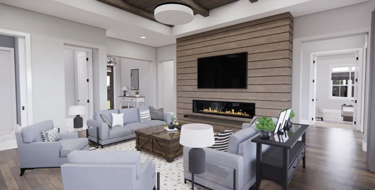 Great room with gray seats, a rustic coffee table, and a fireplace with a TV on top.