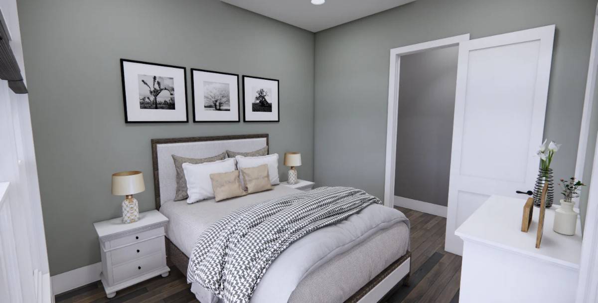 The guest bedroom has a hardwood floor and gray walls adorned with framed artworks.