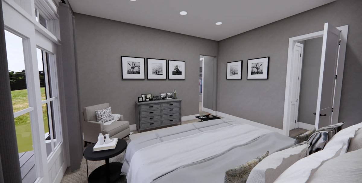 Primary bedroom with a gray armchair and a wooden dresser over the carpeted floor.
