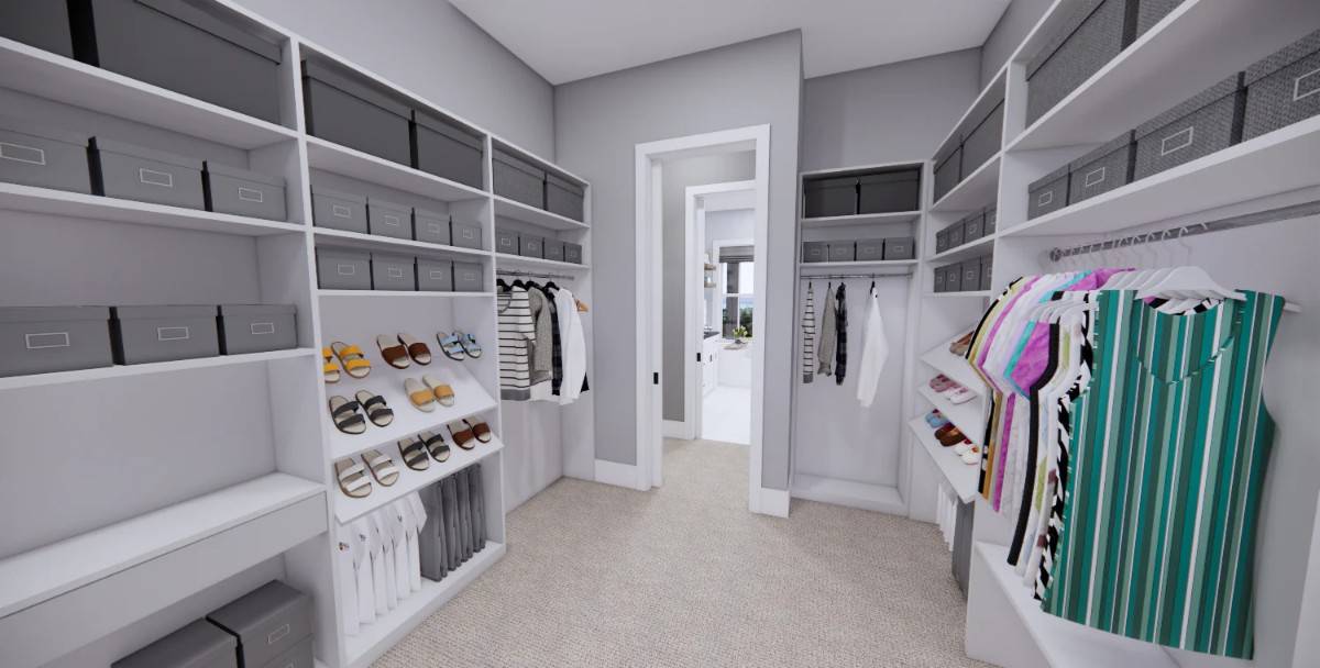 Spacious walk-in closet with ample storage and carpet flooring.