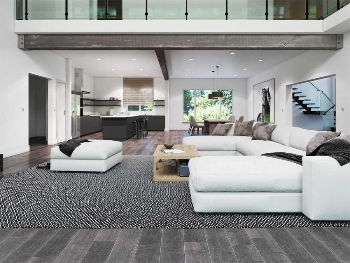 The great room features modern seats and a wooden coffee table over a patterned area rug.
