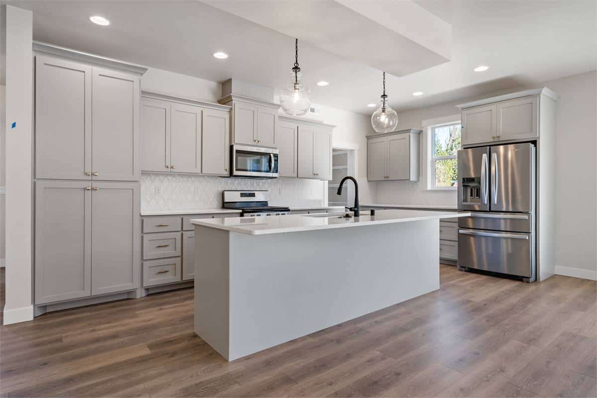 A couple of glass globe pendants along with recessed ceiling lights illuminate the kitchen.
