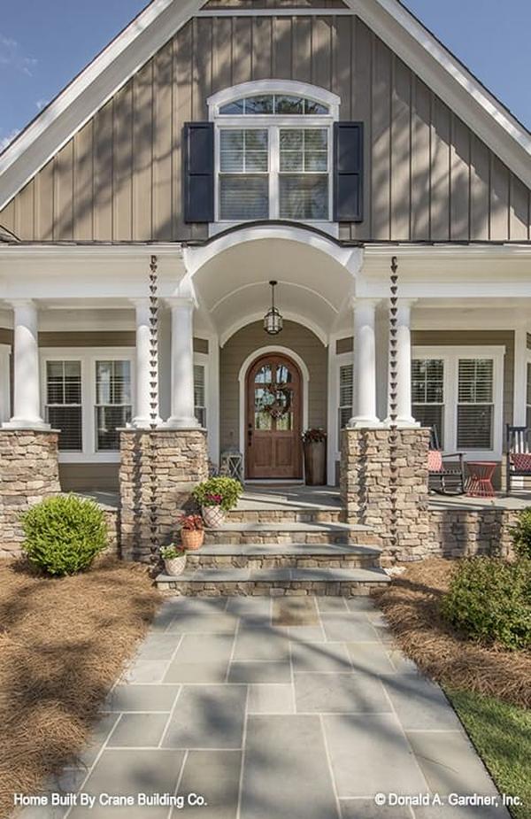 Home entry with a barrel-vaulted ceiling, double columns, and an arched front door.