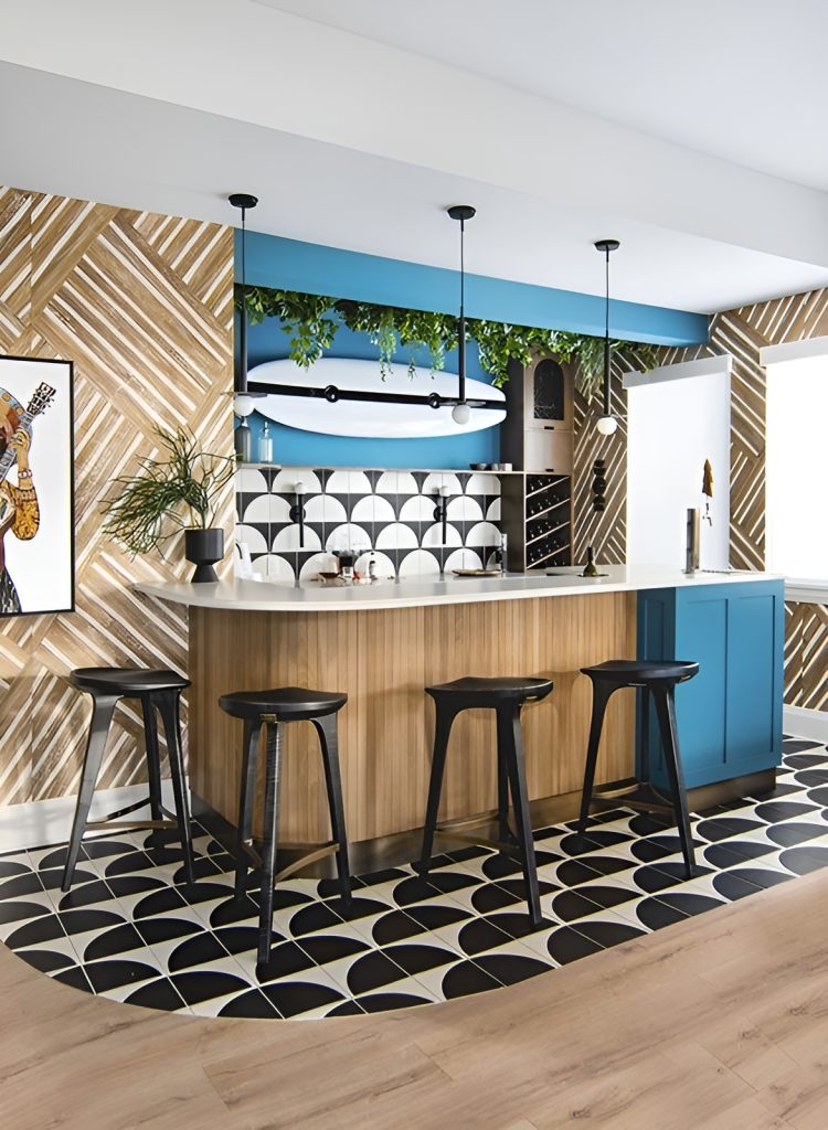 Wet bar with wrought iron pendants and black bar stools lining the curved counter.