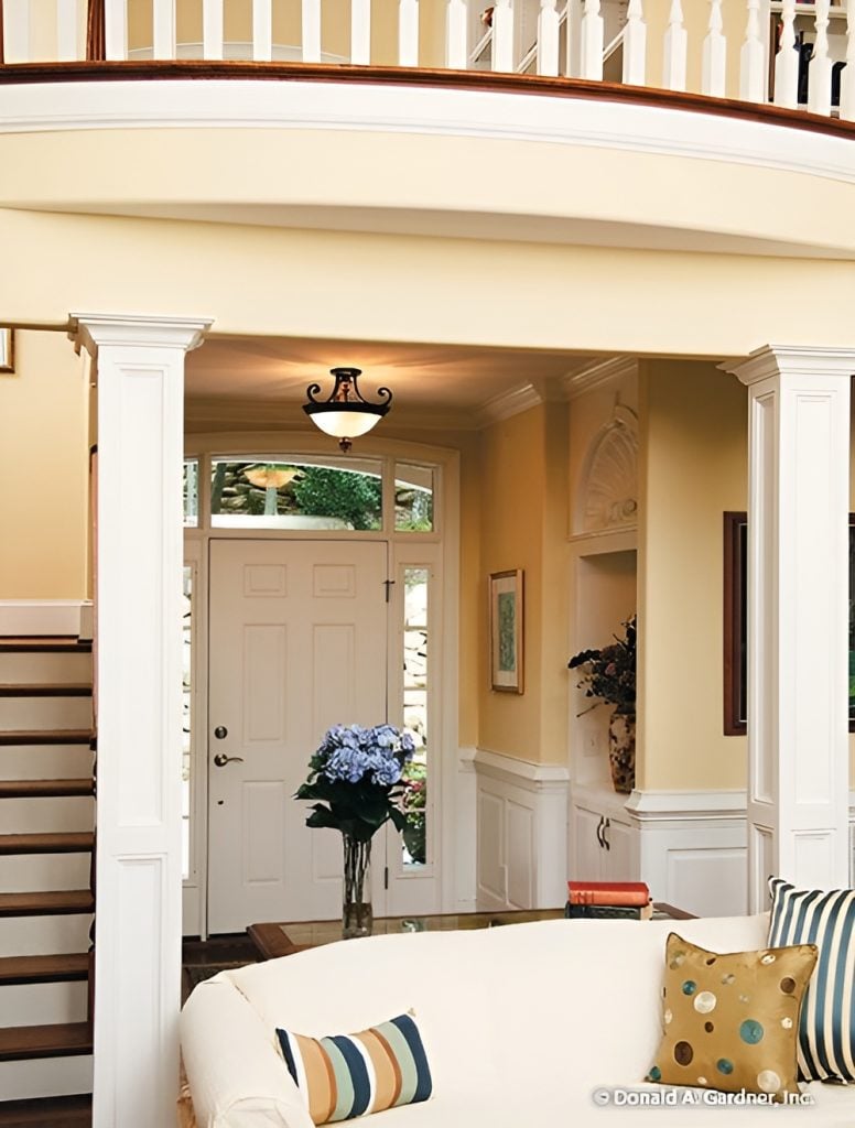 The foyer features a white entry door surrounded by sidelights and a transom window.