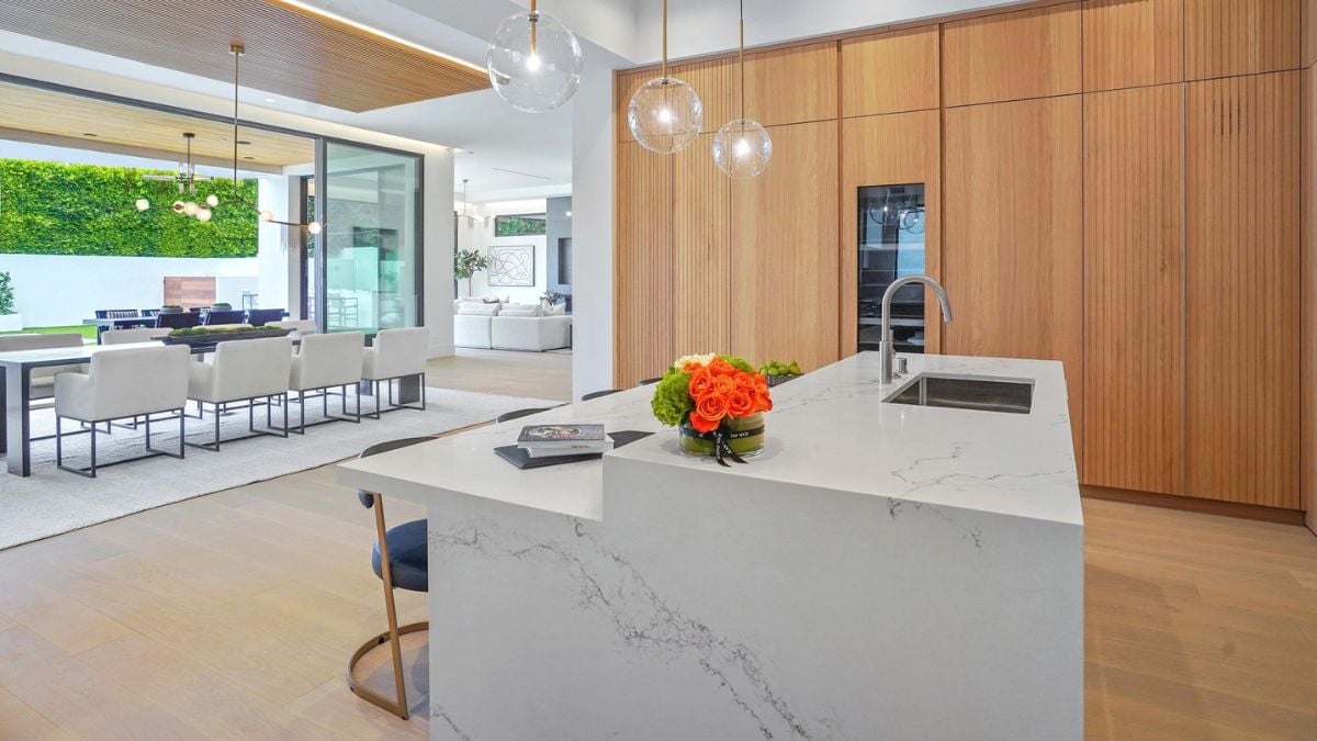 From another perspective, the kitchen counter offers a view of the dining area and the inviting outdoor scenery.