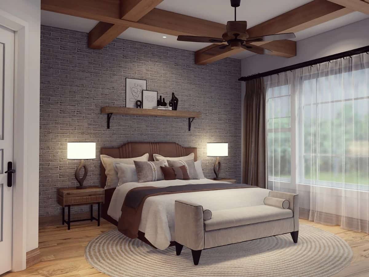 Primary bedroom with a coffered ceiling and a brick accent wall that adds a striking focal point to the room.