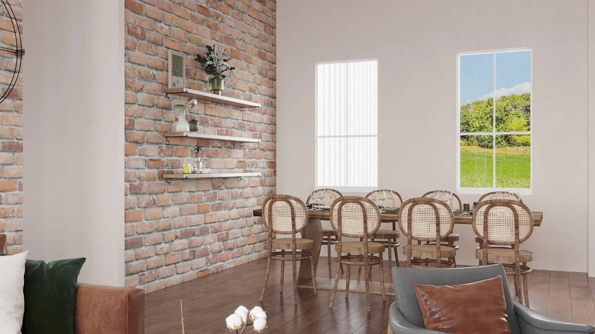 Dining room with hardwood flooring and a brick accent wall mounted with floating shelves.