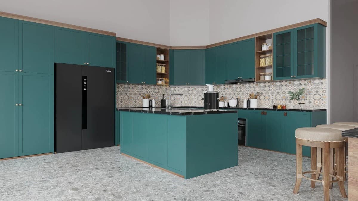 The kitchen includes green cabinetry, black appliances, and a center island fitted with a sink.