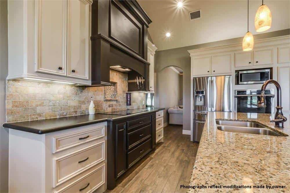 The kitchen includes modern appliances and a shortcut to the home office through an archway.