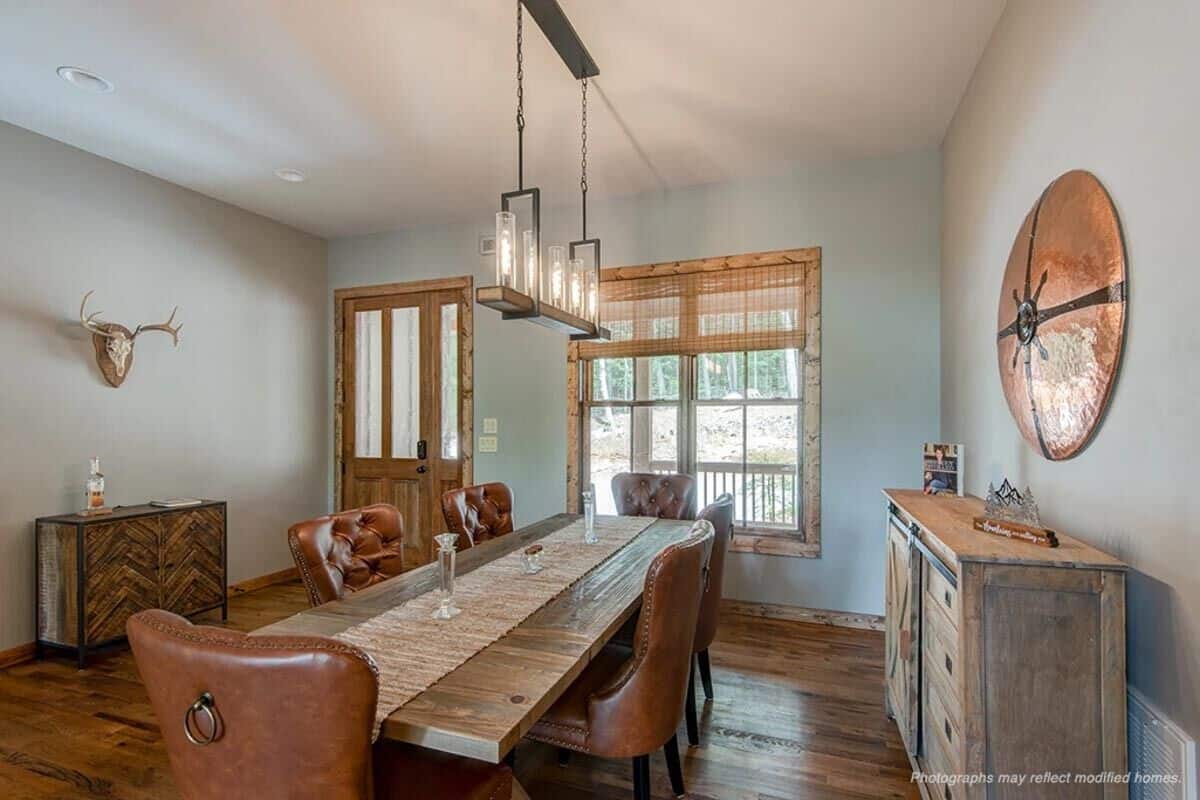 A glazed entry door opens into the foyer and dining room with a hardwood floor and gray walls.
