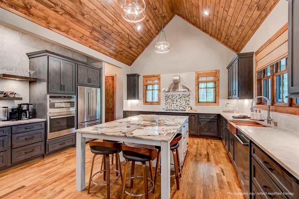 The kitchen is equipped with modern appliances, a farmhouse sink, and a large center island.