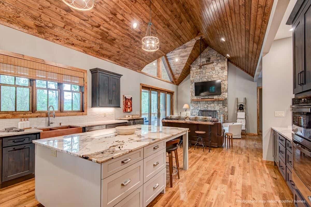 The vaulted ceiling runs through the adjacent kitchen.