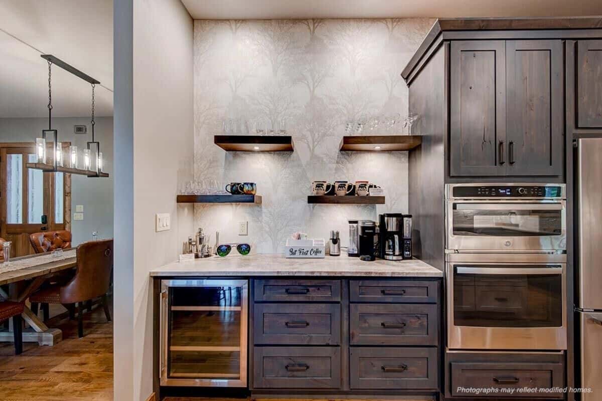 The kitchen includes a coffee bar with a beverage fridge and floating shelves.
