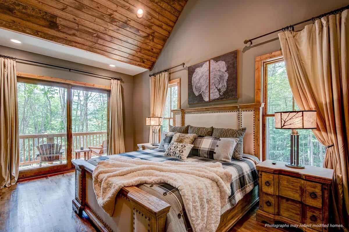 Primary bedroom with a vaulted ceiling and private access to the back porch through sliding glass doors.