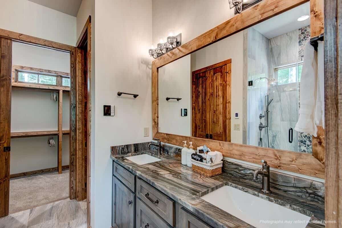 The primary bathroom has a dual sink vanity, a walk-in closet, and a tiled shower reflected in the mirror.
