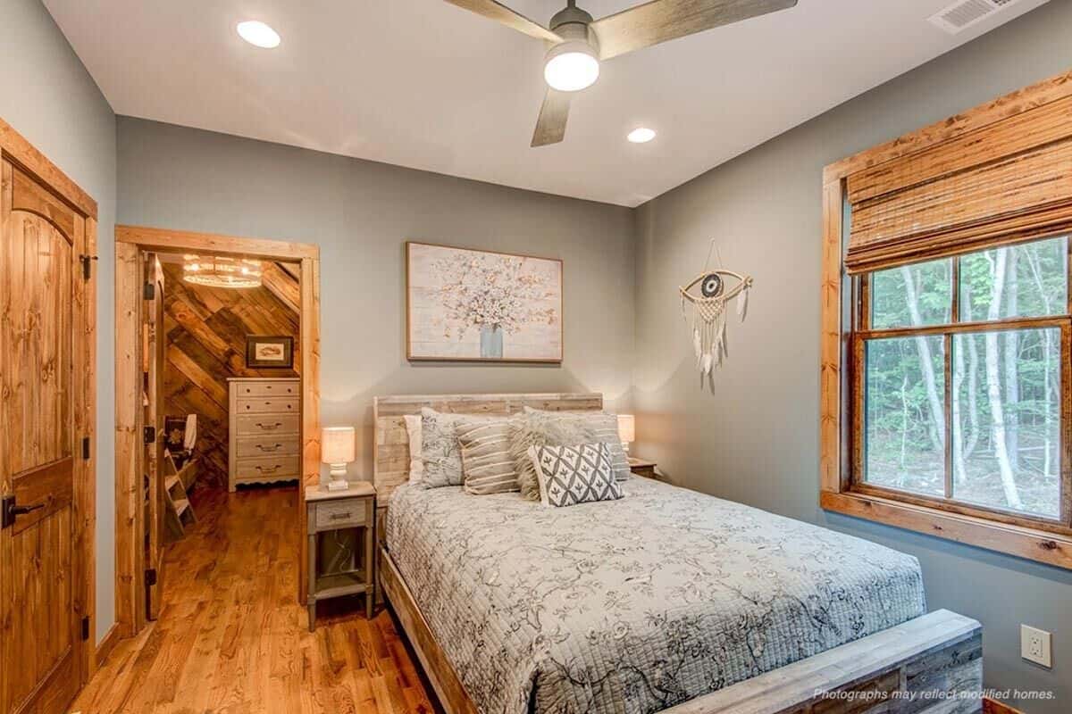 The third bedroom has a rustic bed and a walk-in closet.