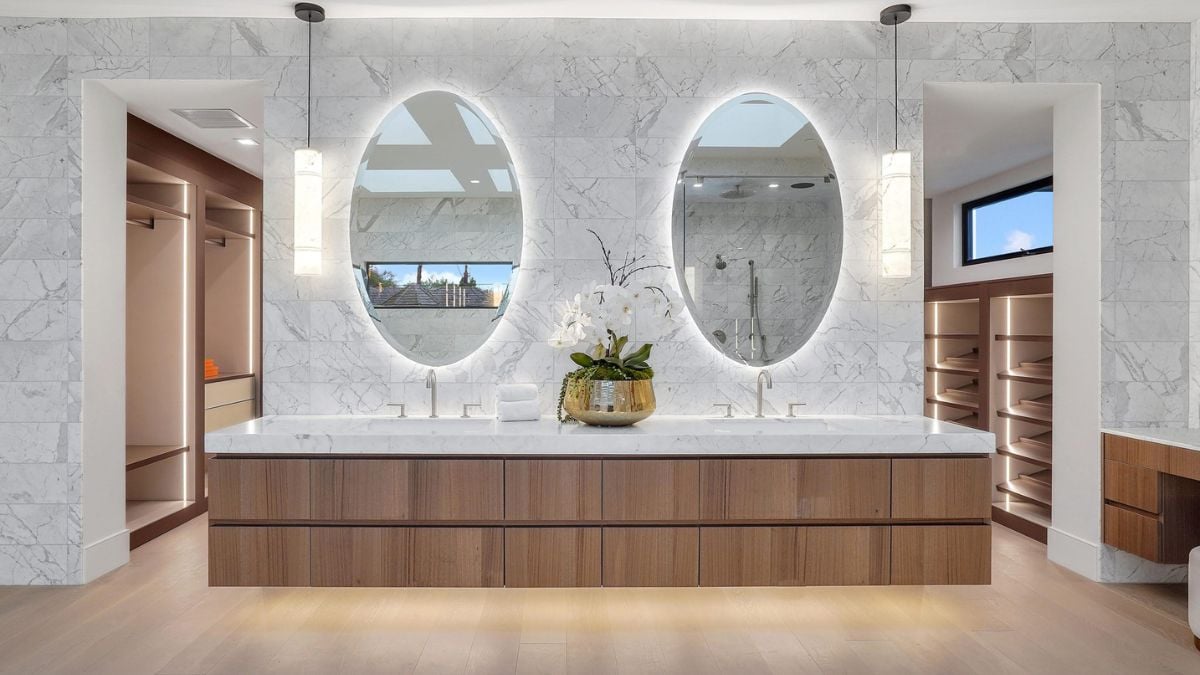 Experience the natural warmth of the all-stone bathroom, enhanced by the addition of wood cabinets.